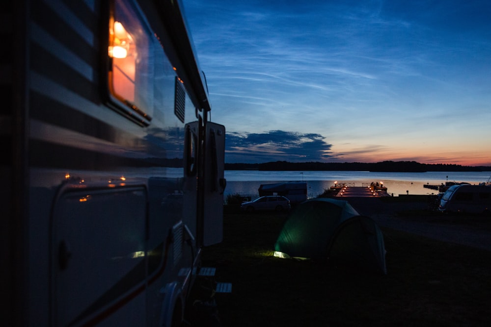 a couple of tents sitting next to a body of water