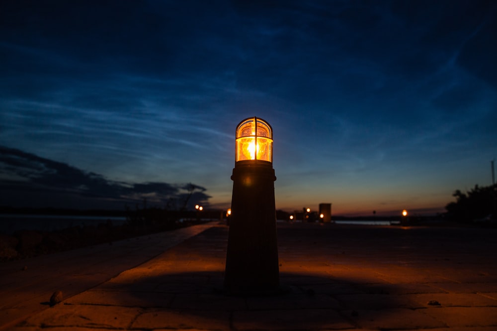 a street light sitting on the side of a road