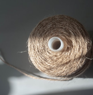 a spool of twine of twine on a white surface