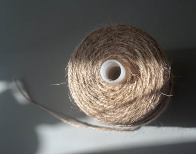 a spool of twine of twine on a white surface