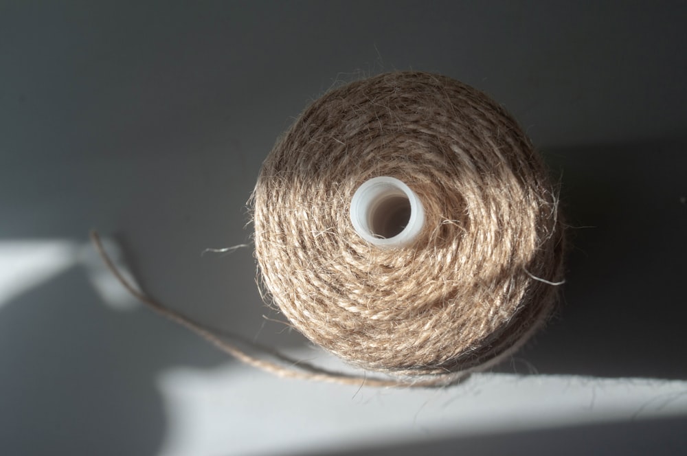 a spool of twine of twine on a white surface