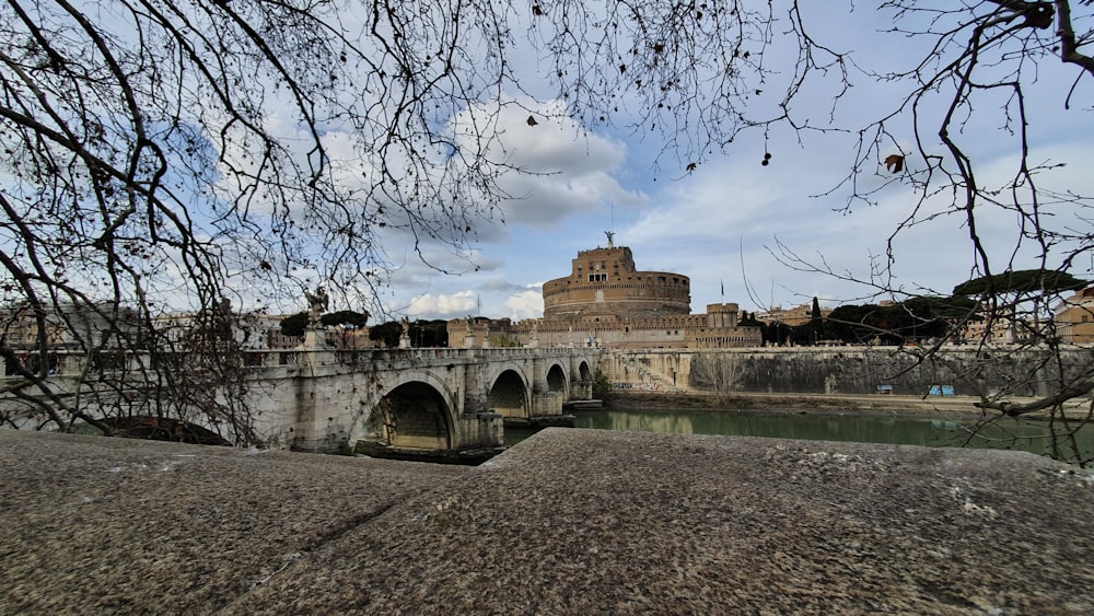 a bridge over a river with a tower in the background