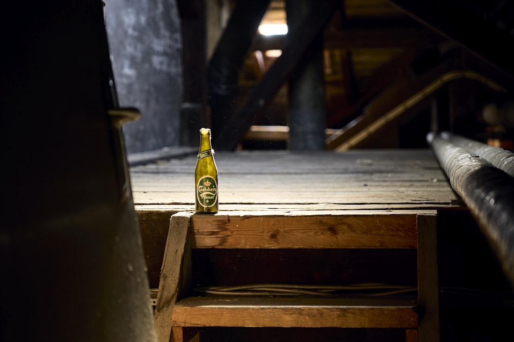 a beer bottle sitting on top of a wooden table