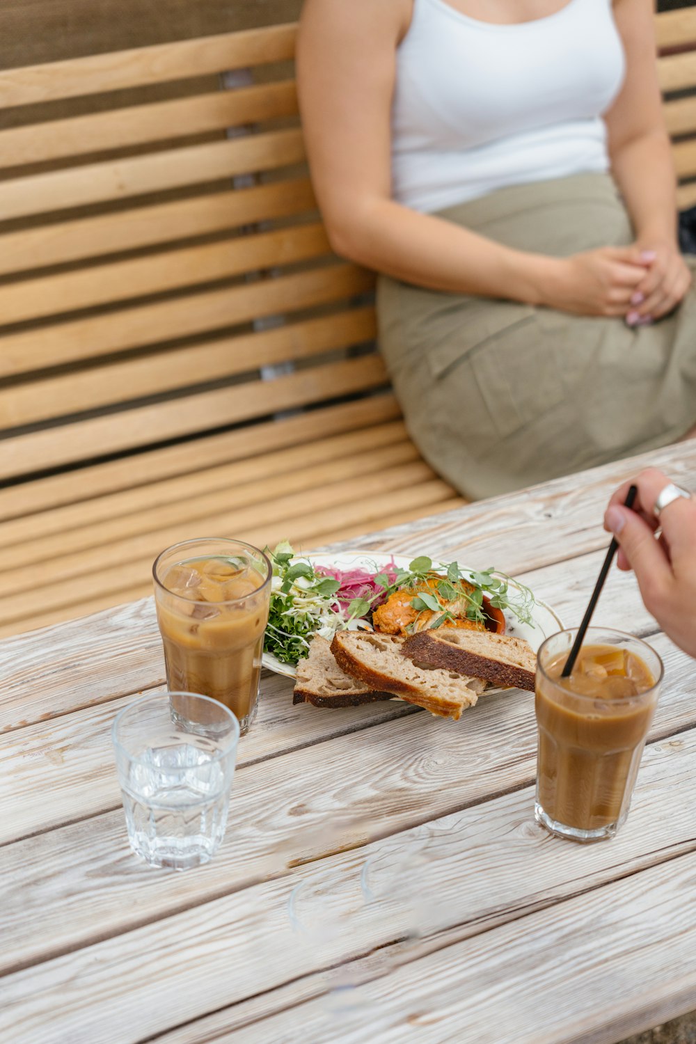 a person sitting at a table with a plate of food