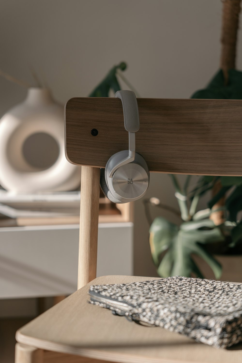 a close up of a wooden chair with headphones on it