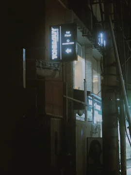 Close-up of a stylish beauty salon illuminated by warm lights against the night.