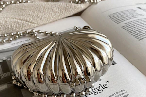 A vibrant red party clutch sparkling under soft lighting on a marble surface.