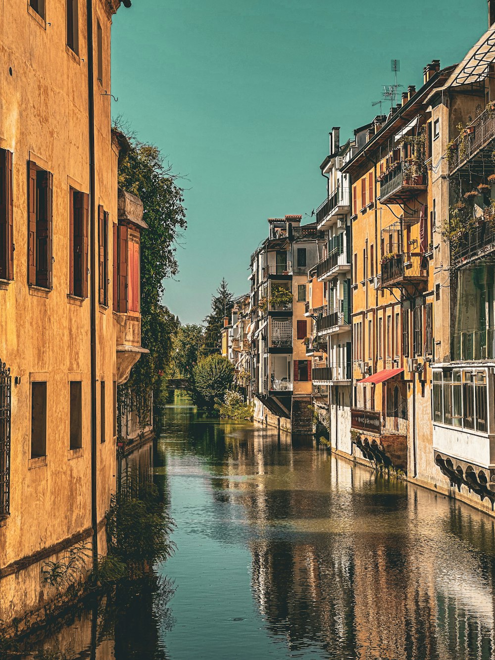 a river running through a city next to tall buildings