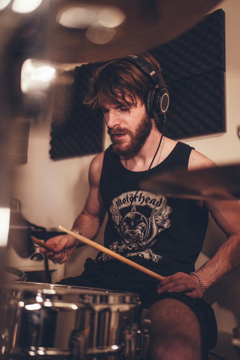 a man sitting in front of a drum set