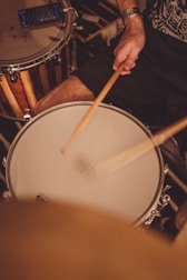 a man is playing drums in a room