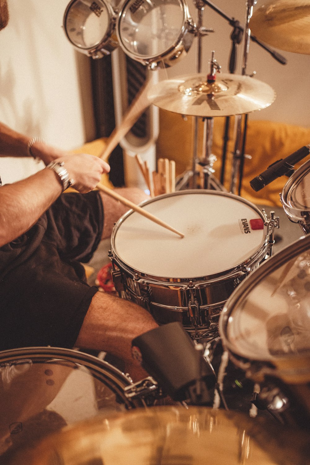 a man sitting in front of a drum set