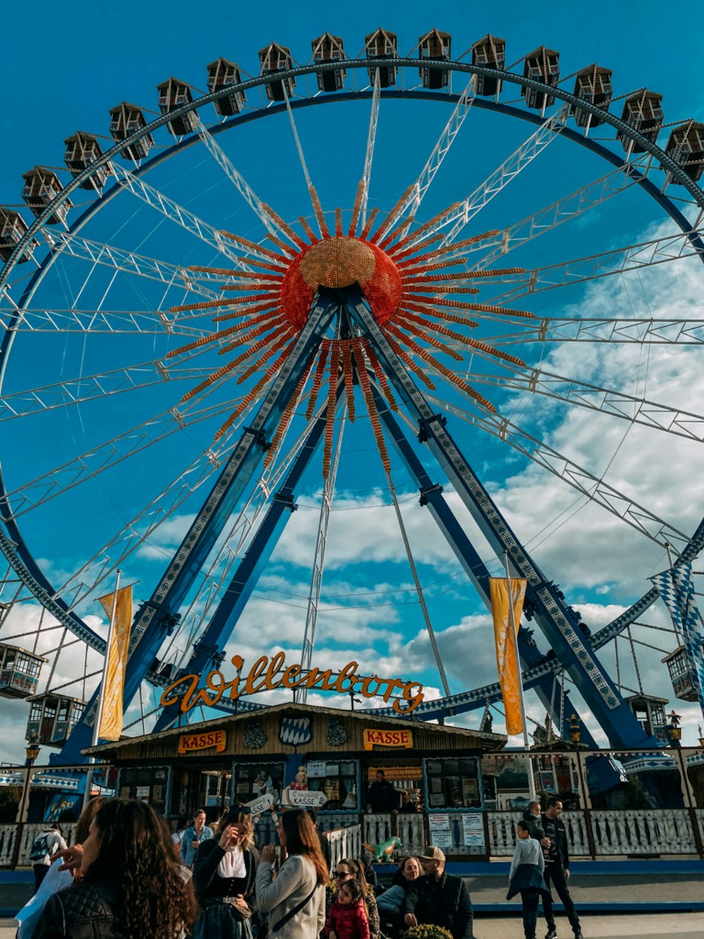 a large ferris wheel sitting above a crowd of people