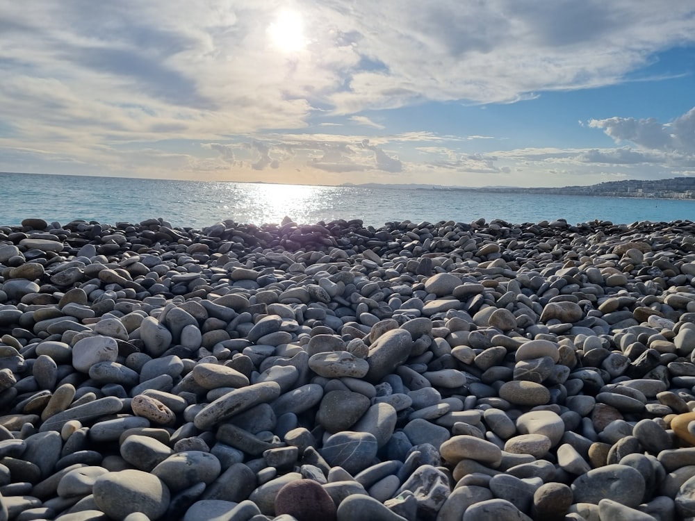 a bunch of rocks that are by the water