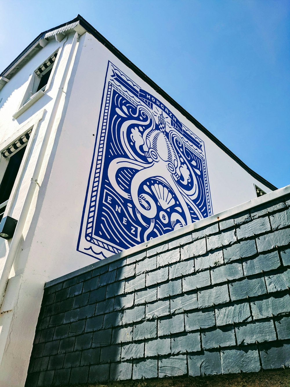 a blue and white picture on the side of a building