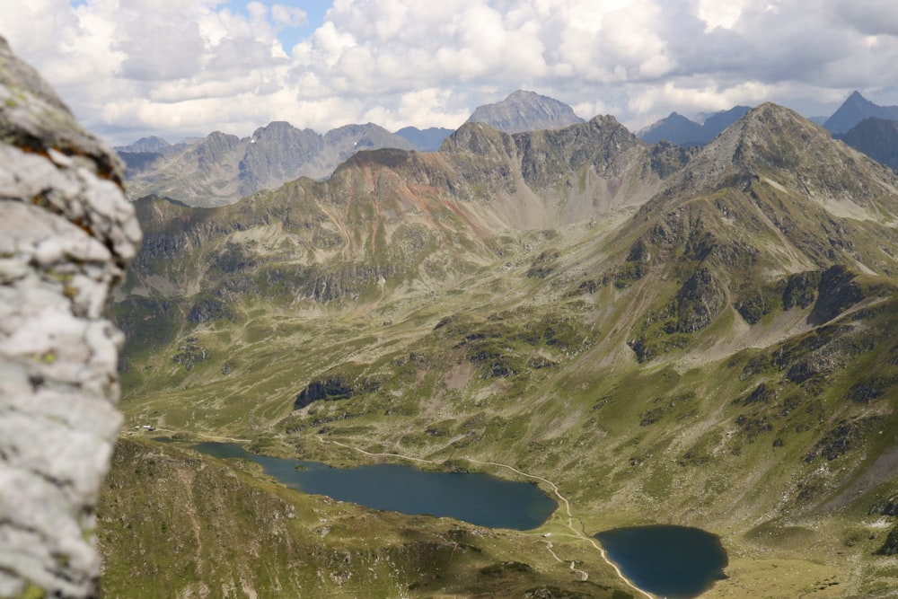 a view of a mountain range with a lake in the foreground