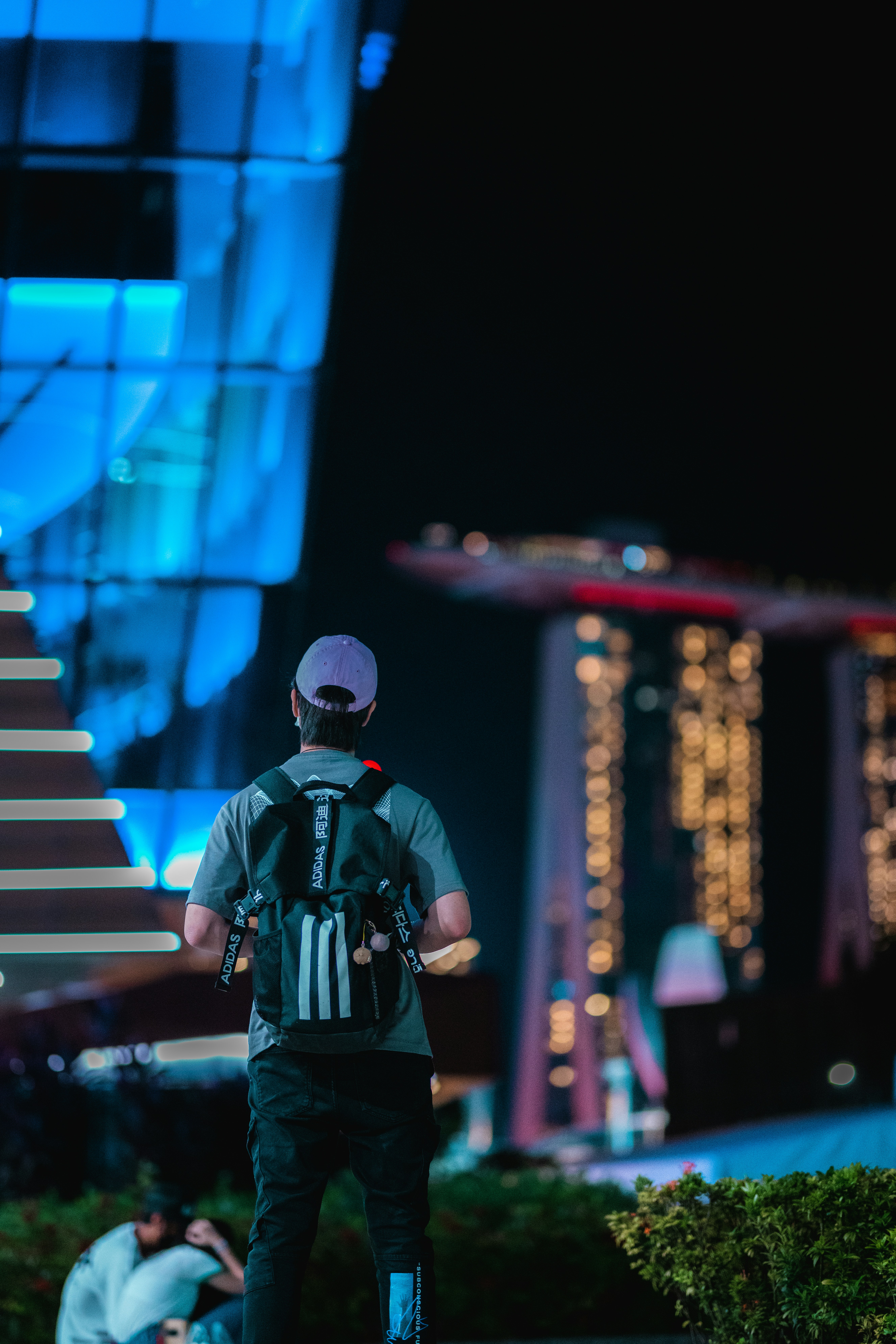 a man riding a skateboard down a street at night