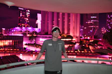 Room balcony overlooking the vibrant city lights at night.