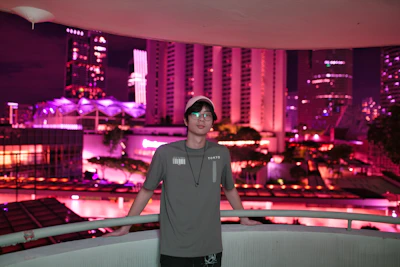 Balcony view overlooking a vibrant cityscape in the evening.
