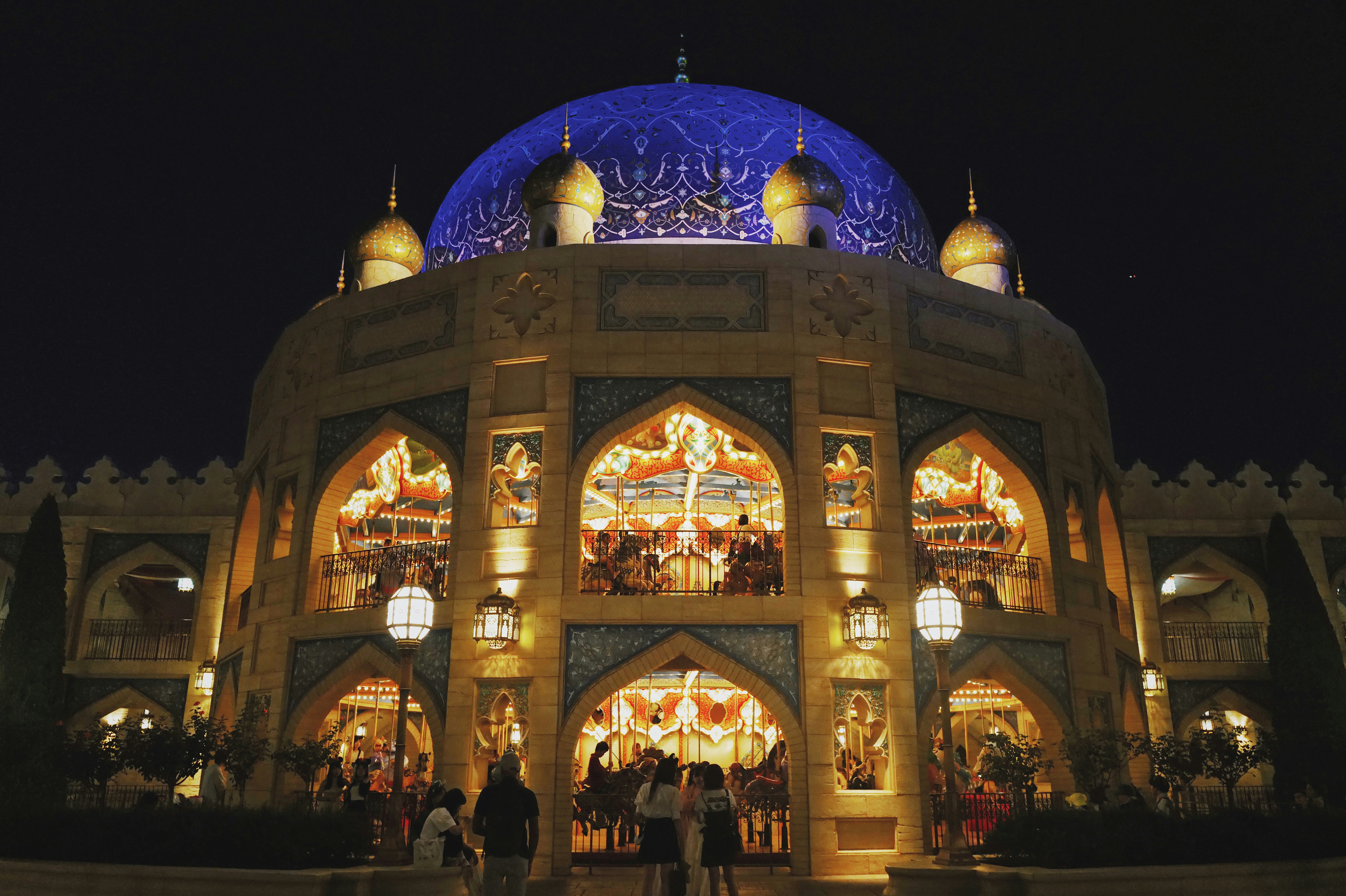 a large building with a blue dome at night