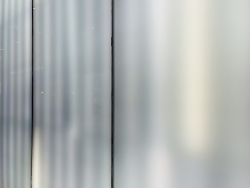 Close-up of a PDLC smart film panel transitioning from opaque to transparent in a modern conference room.