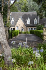 A cobblestone driveway winding through a charming Cape Cod home.