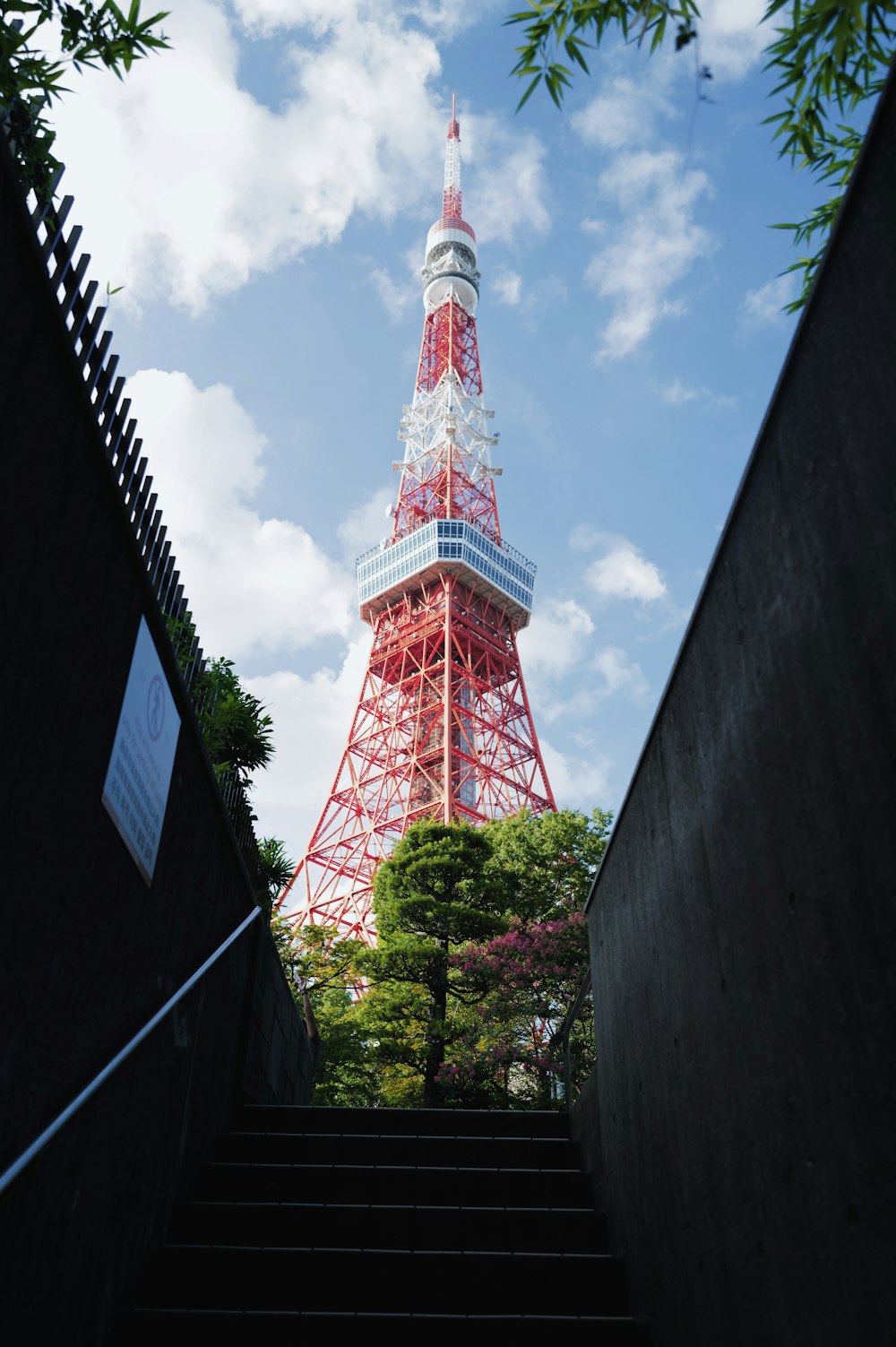 a view of the eiffel tower from the bottom of a flight of stairs