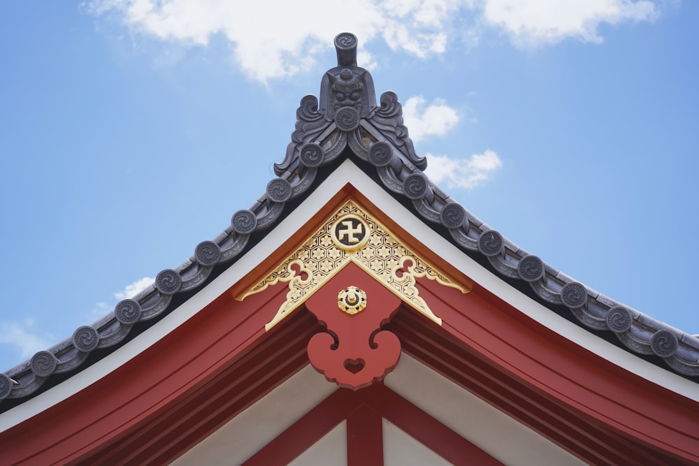 a red and white building with a sky background