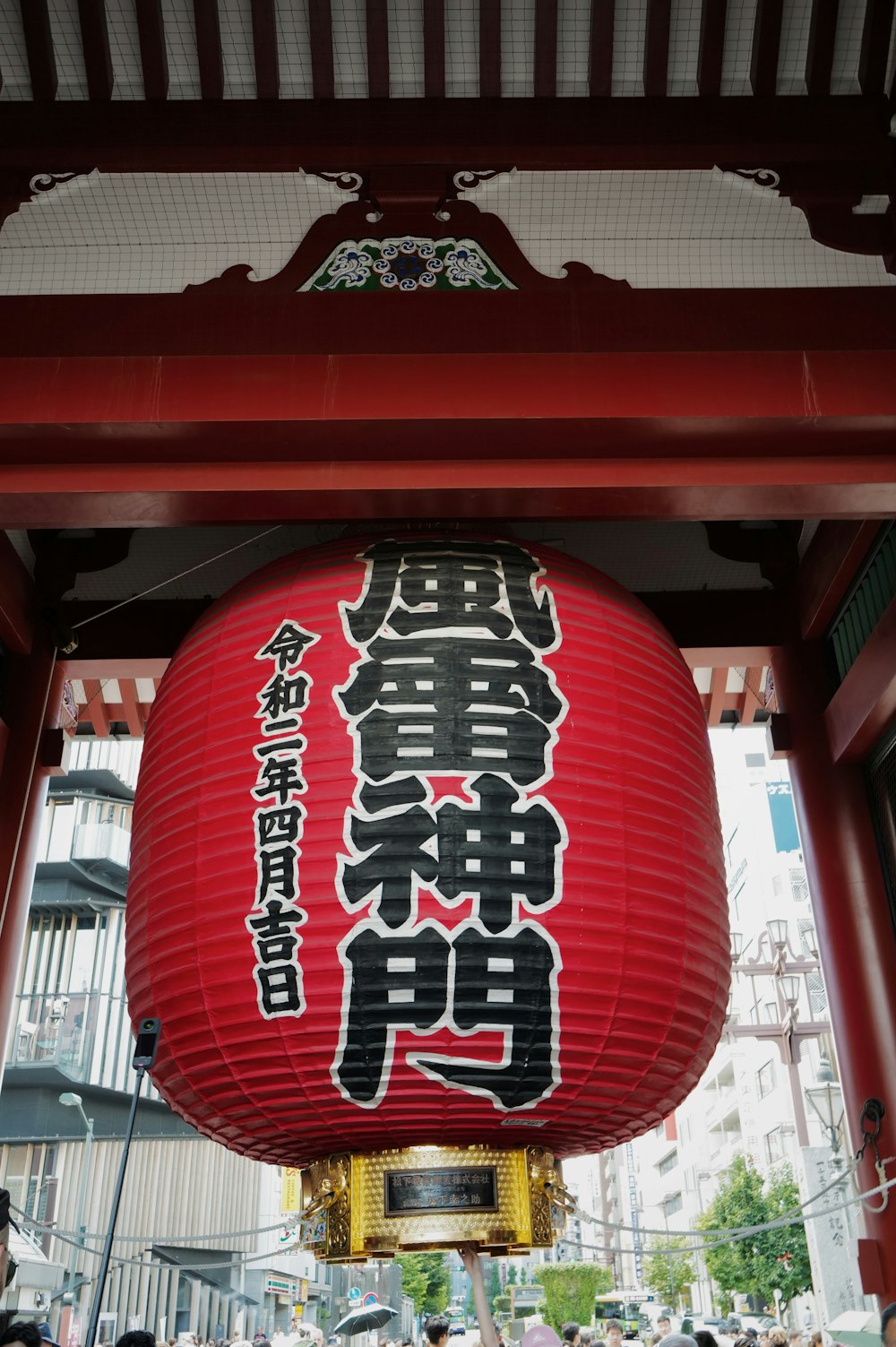 a large red lantern hanging from the side of a building