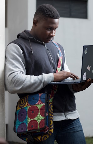 a man with a laptop in his hand
