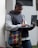 A focused young man studying with a laptop and notes, symbolizing ambition and learning.