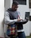 A focused young man studying with a laptop and notes, symbolizing ambition and learning.