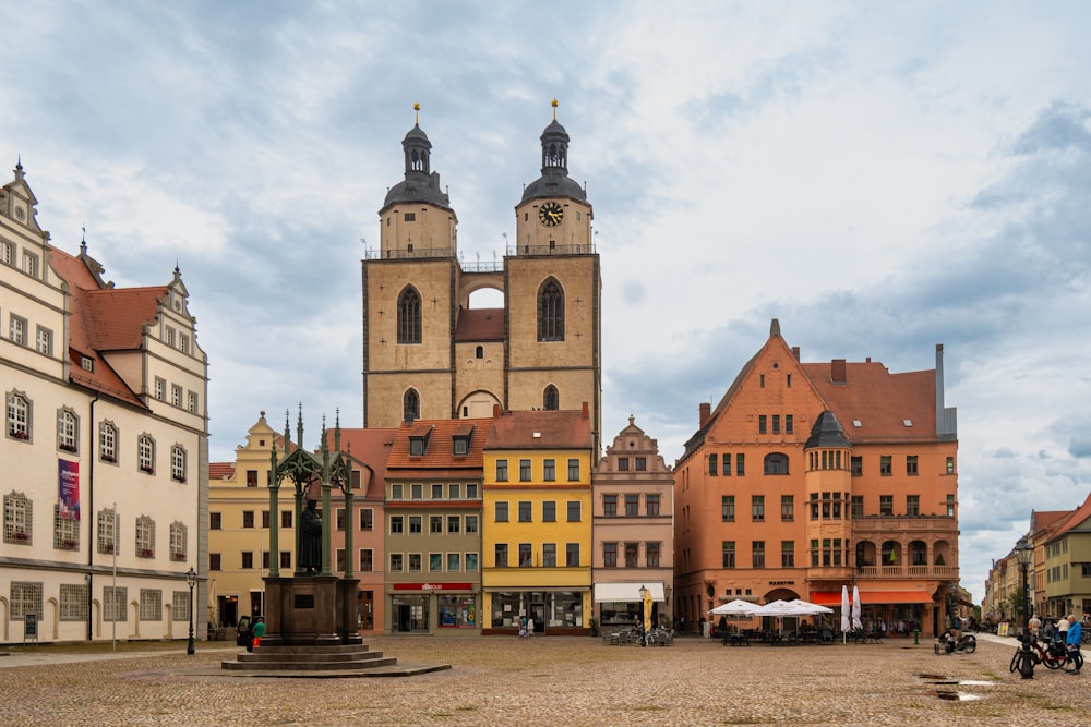 a group of buildings with a clock tower in the background