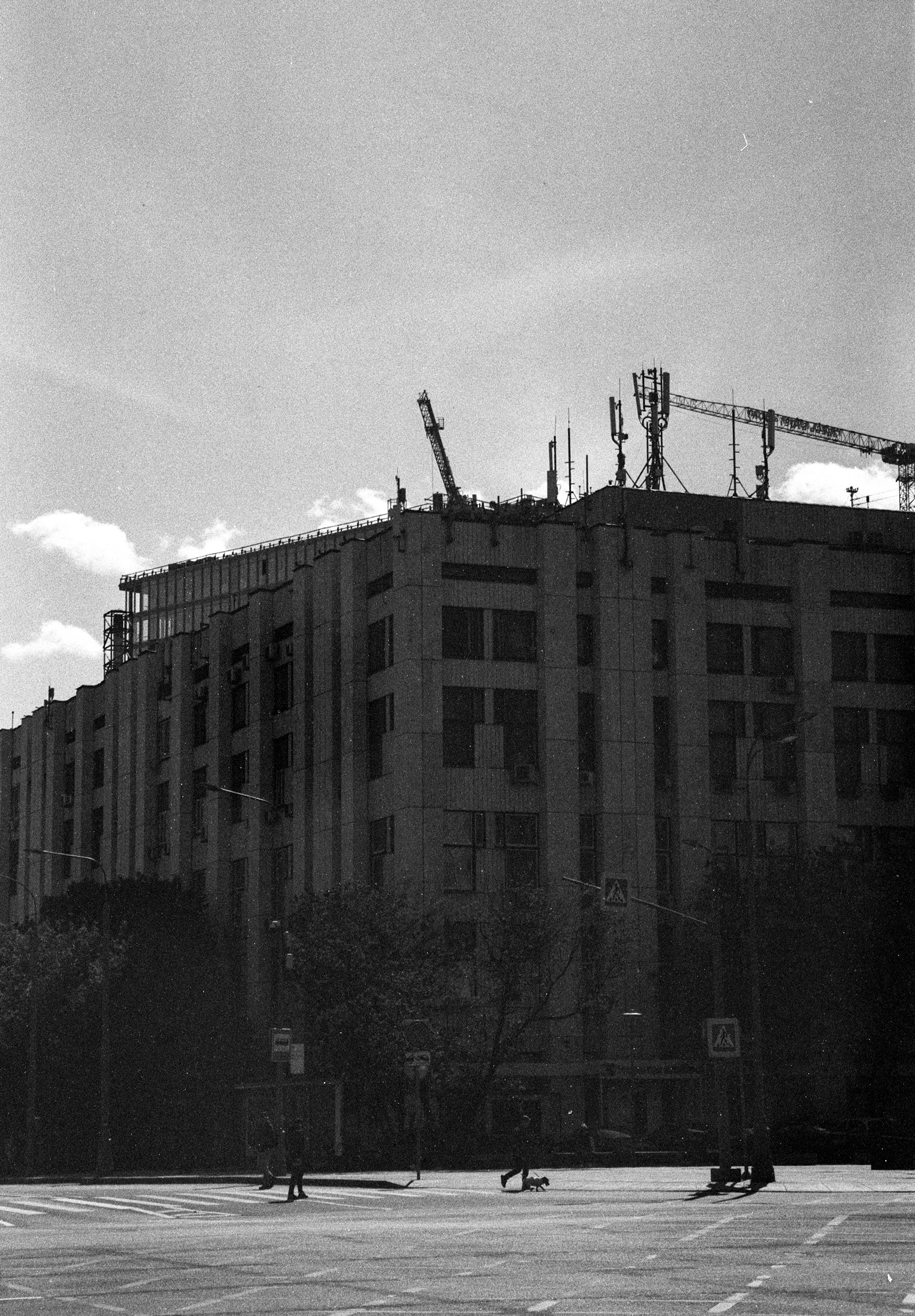 a black and white photo of a building under construction