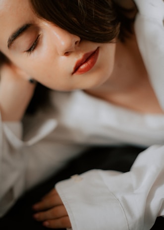 A peaceful face with closed eyes, exhaling slowly, embodying relaxation and focus.