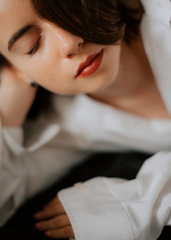 Close-up of a person calmly breathing with eyes closed, showing focus and relaxation.