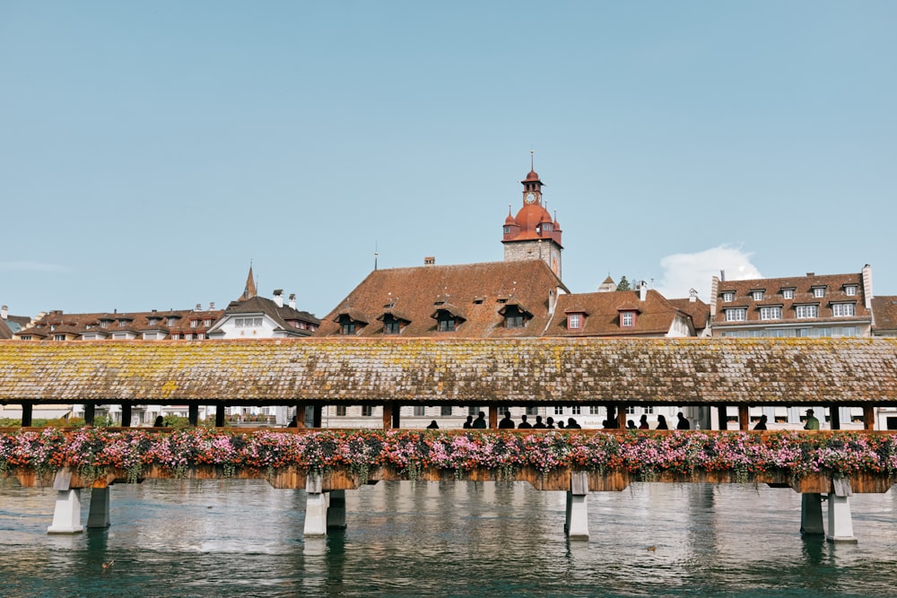 a building with a clock tower on top next to a body of water