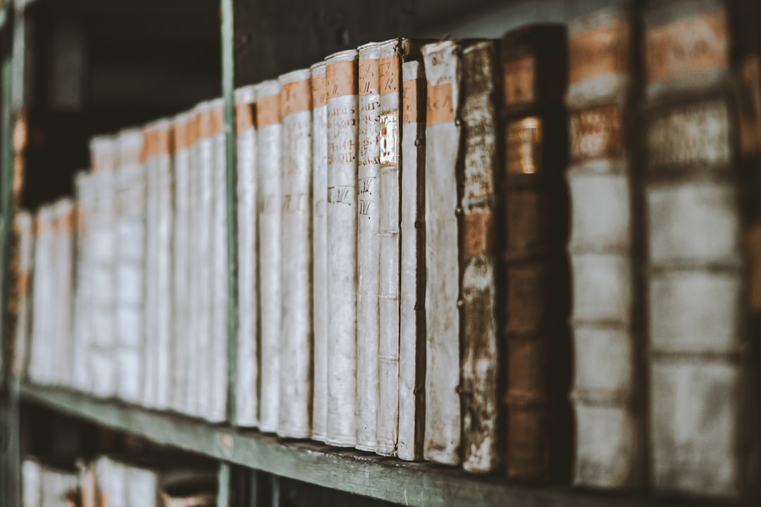 a bunch of books that are on a shelf,