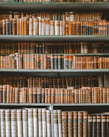 Bookshelves filled with legal books and codes in a sophisticated law firm library.
