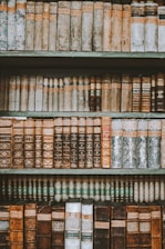 A selection of beautifully restored books displayed on a wooden shelf.