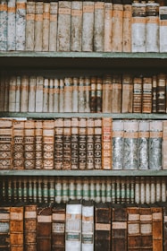 A selection of beautifully restored books displayed on a wooden shelf.