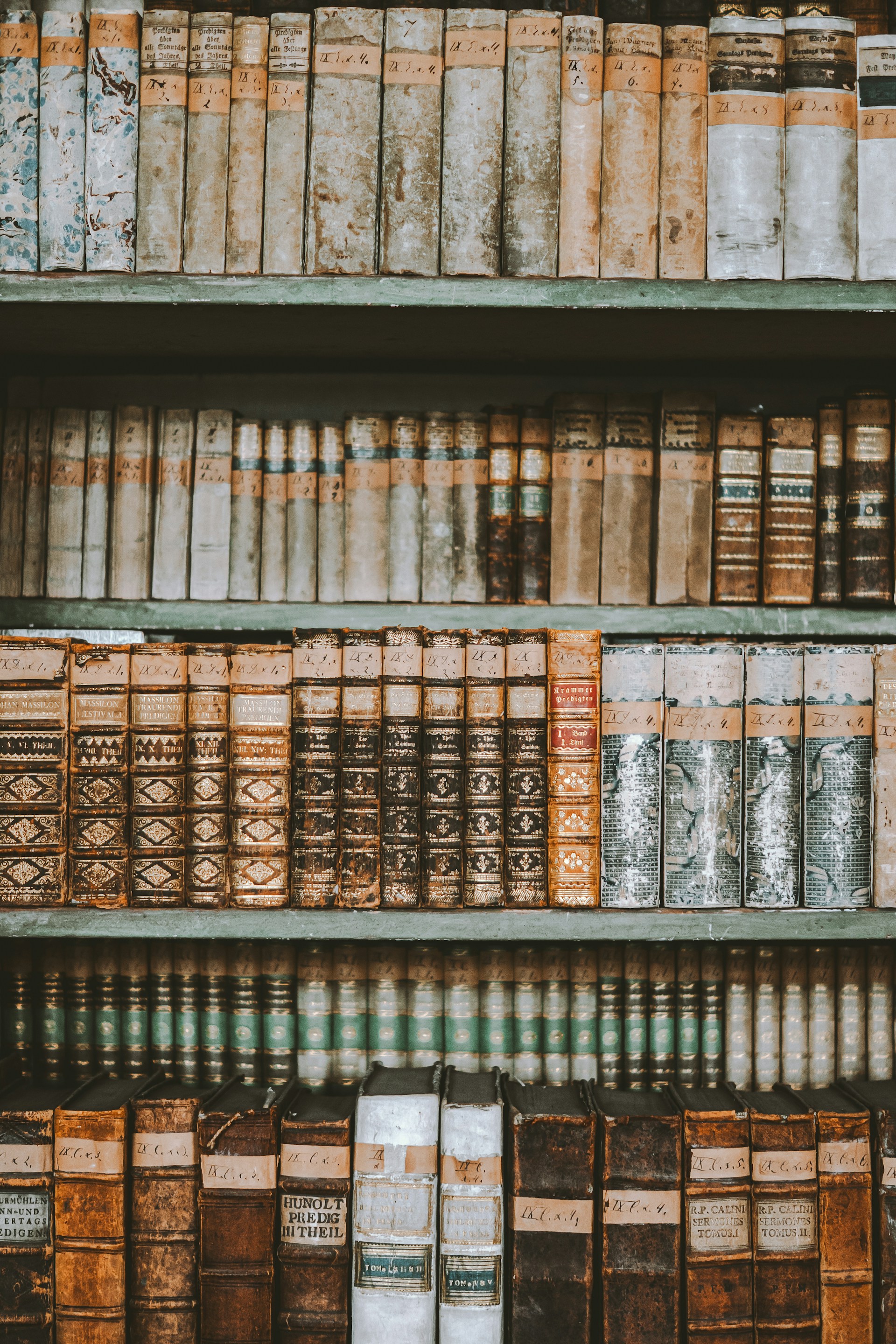 a bookshelf filled with lots of old books