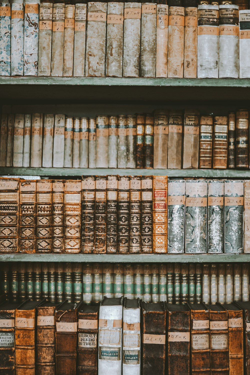a bookshelf filled with lots of old books