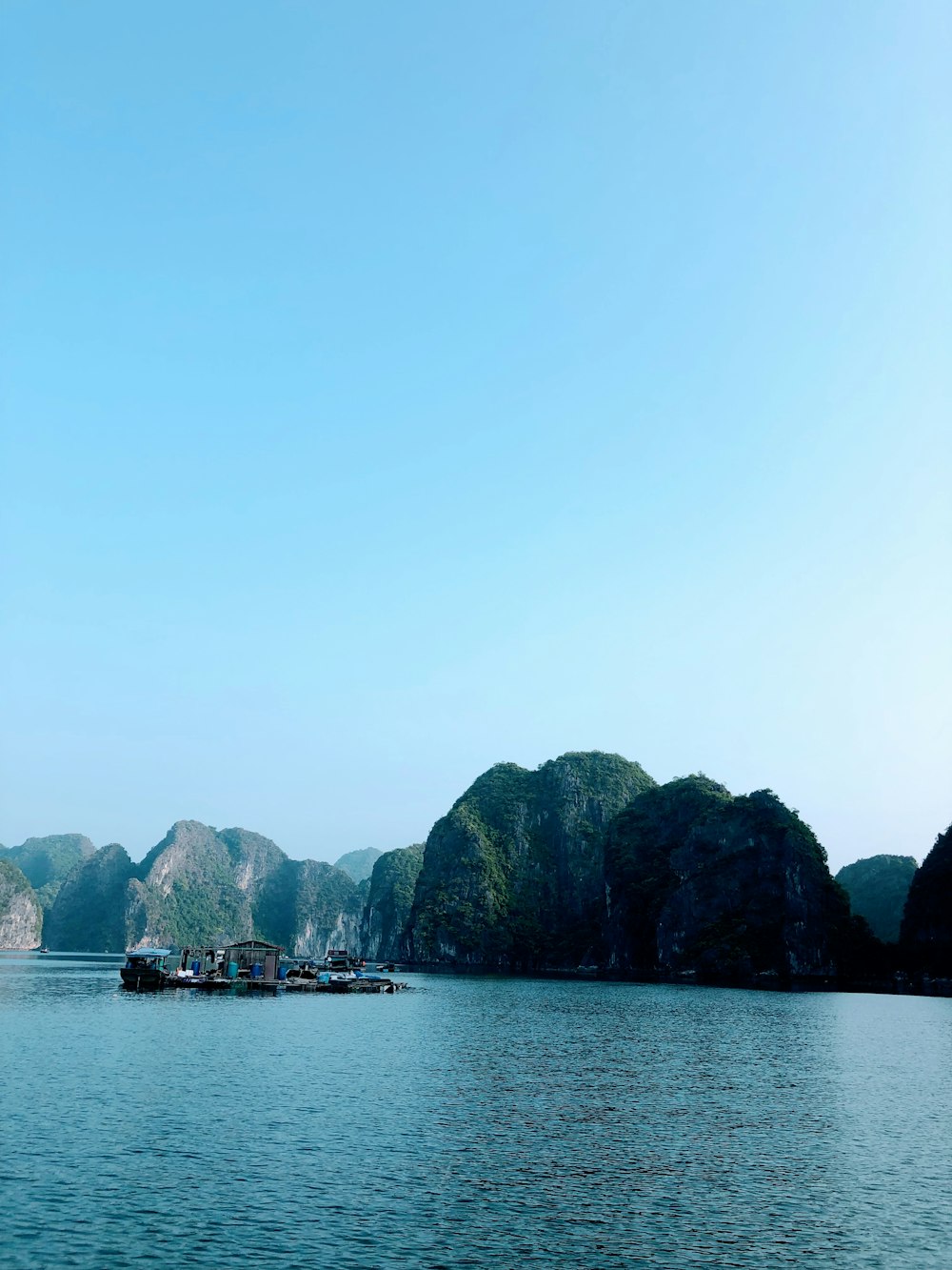 a group of boats floating on top of a large body of water