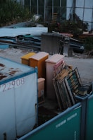 a dumpster filled with lots of junk next to a building