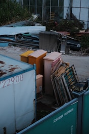 a dumpster filled with lots of junk next to a building