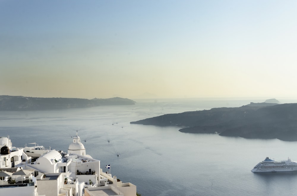 a cruise ship in the water near a white building