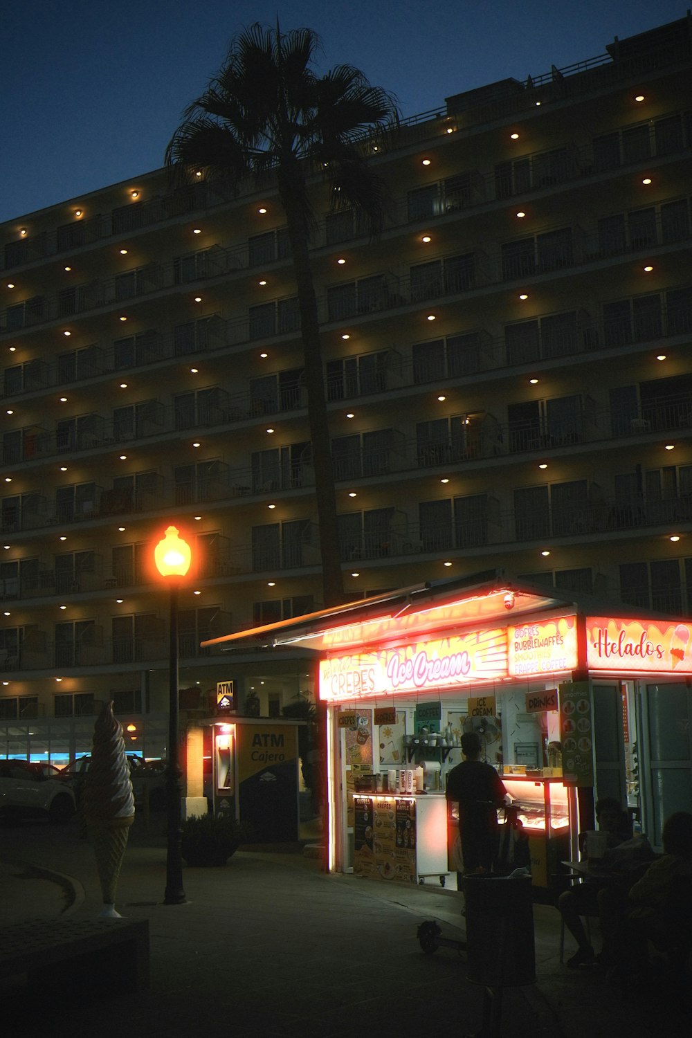 a person standing on a sidewalk in front of a building