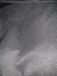 Detailed texture of elegant wool fabric in dark gray tone.