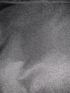 Detailed texture of elegant wool fabric in dark gray tone.