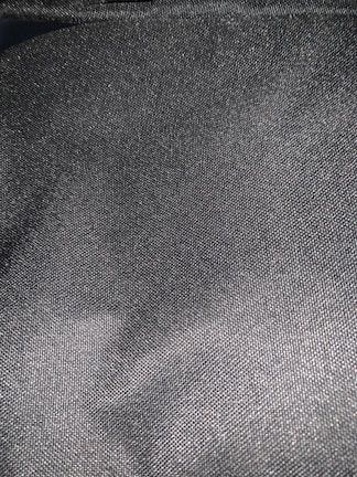 Steel grey fabric with subtle metallic sheen under soft light.
